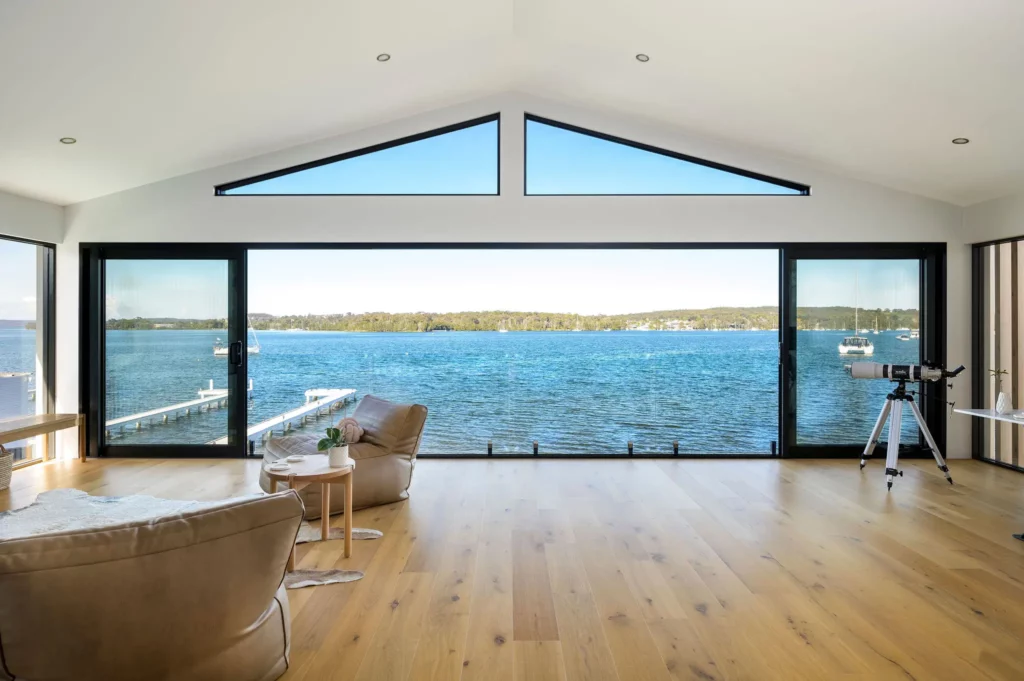 home with large glass windows showing lake macquarie view